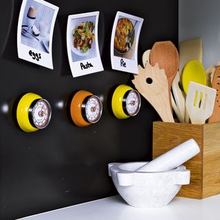 kitchen with wooden spoon with magnetic timers
