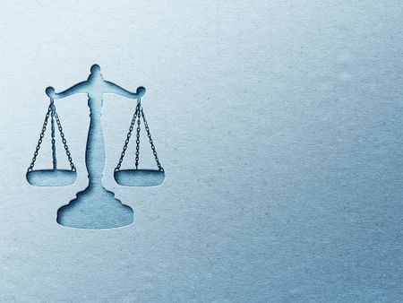 rendering of the scales of justice against a blue background