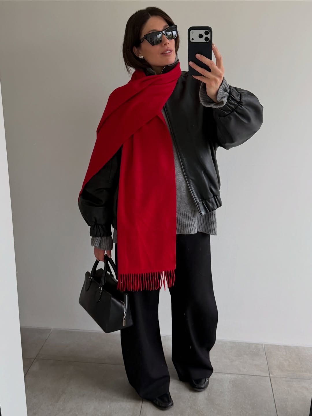 lucy alston wears a cashmere jumper and red scarf