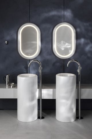 Two cylindrical basins and freestanding taps plus oval mirrors by VitrA and Tom Dixon