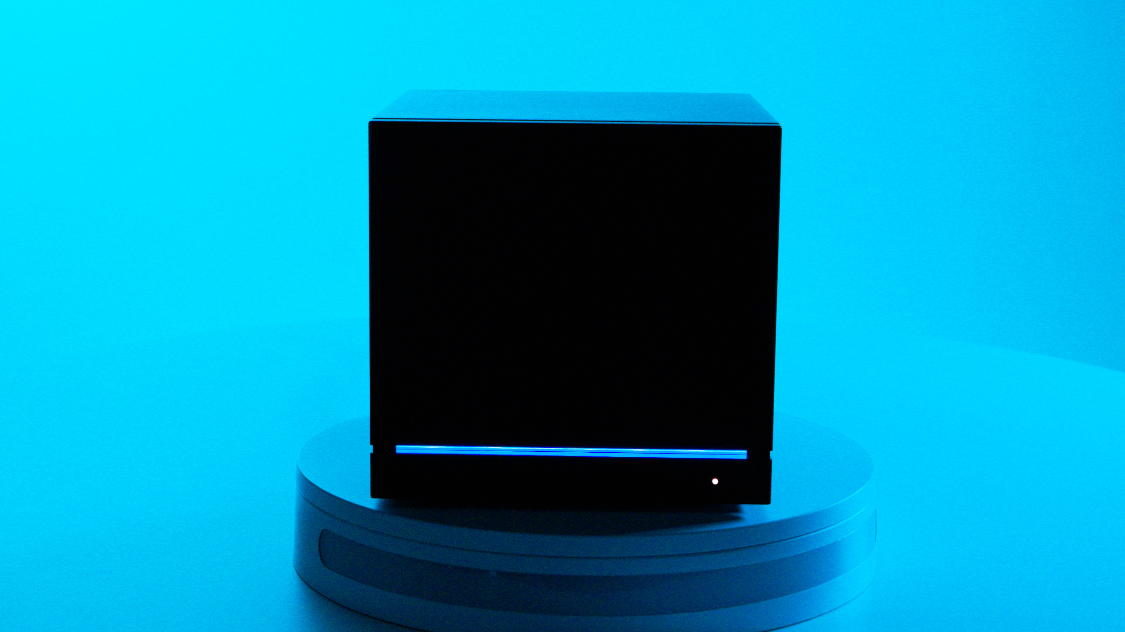 The Steam Machine on a white stand with a blue background and various ports on display.