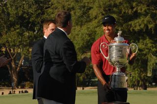 Woods holds the trophy