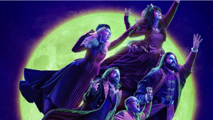 The cast of What We Do In The Shadows flying in front of the moon
