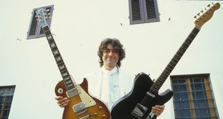 Jimmy Page brandishes a Les Paul and a black Telecaster in an archive photo from 1984