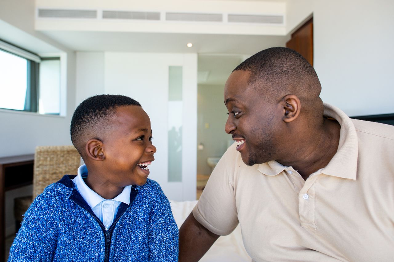 Father and son laughing. 