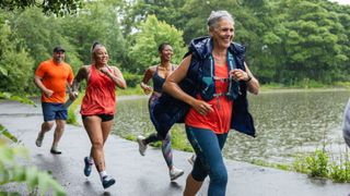 Woman running together in a group with men