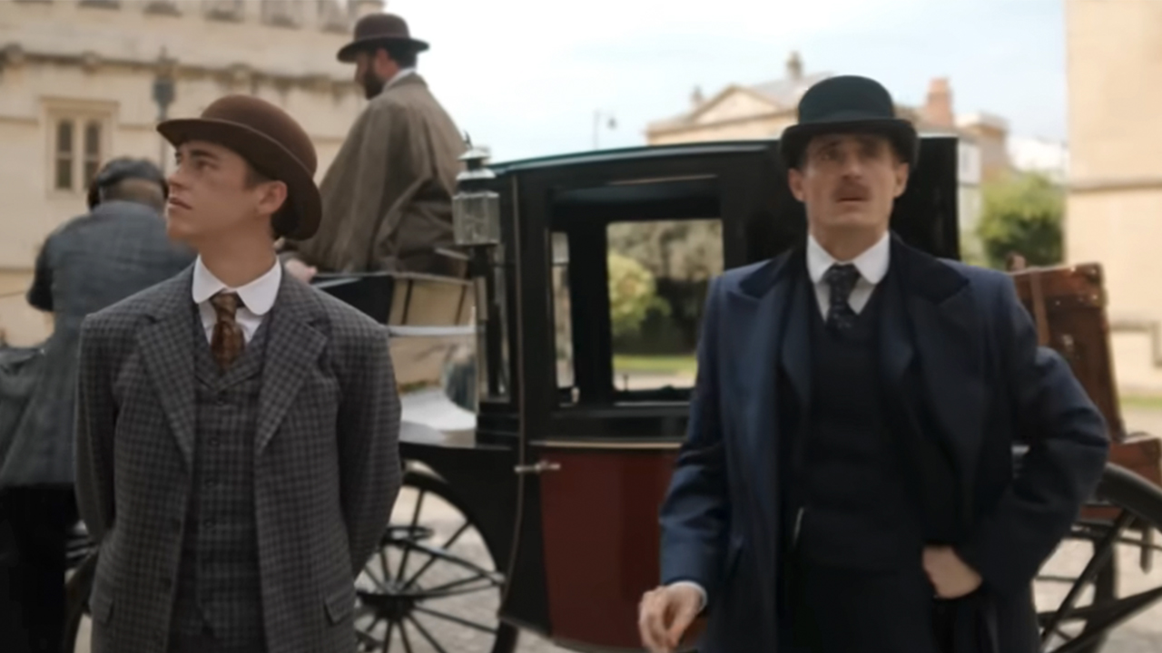 Hero Fiennes Tiffin on the left and Joseph Fiennes on the right, in suits, in Young Sherlock Holmes