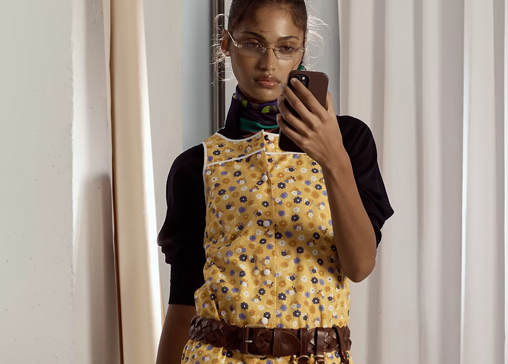 A model wearing a yellow miu miu from SSENSE.