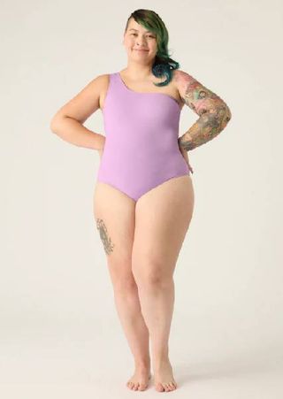 A model wearing a lilac swimsuit from Modibodi