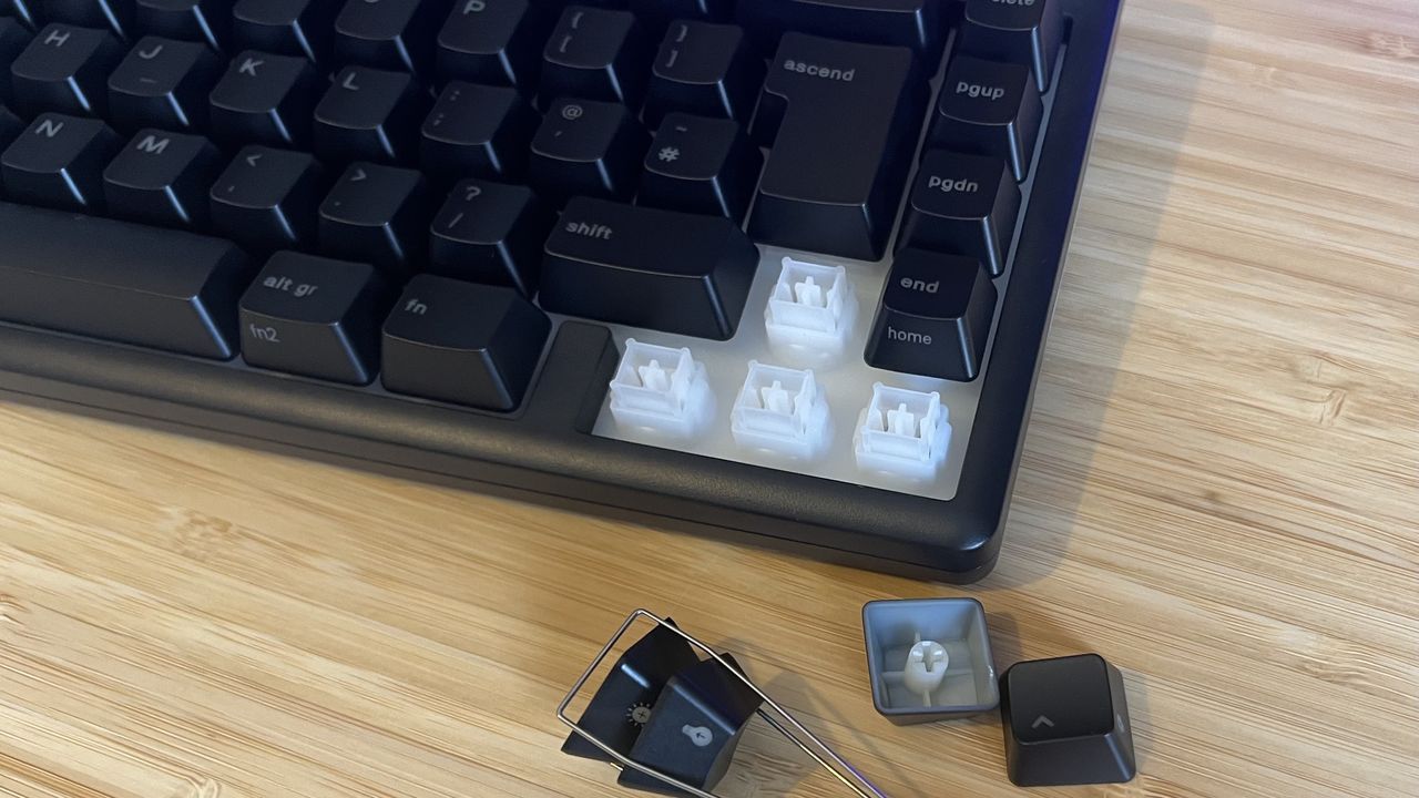 Glorious GMBK 75% gaming keyboard with arrow key caps removed showing switches