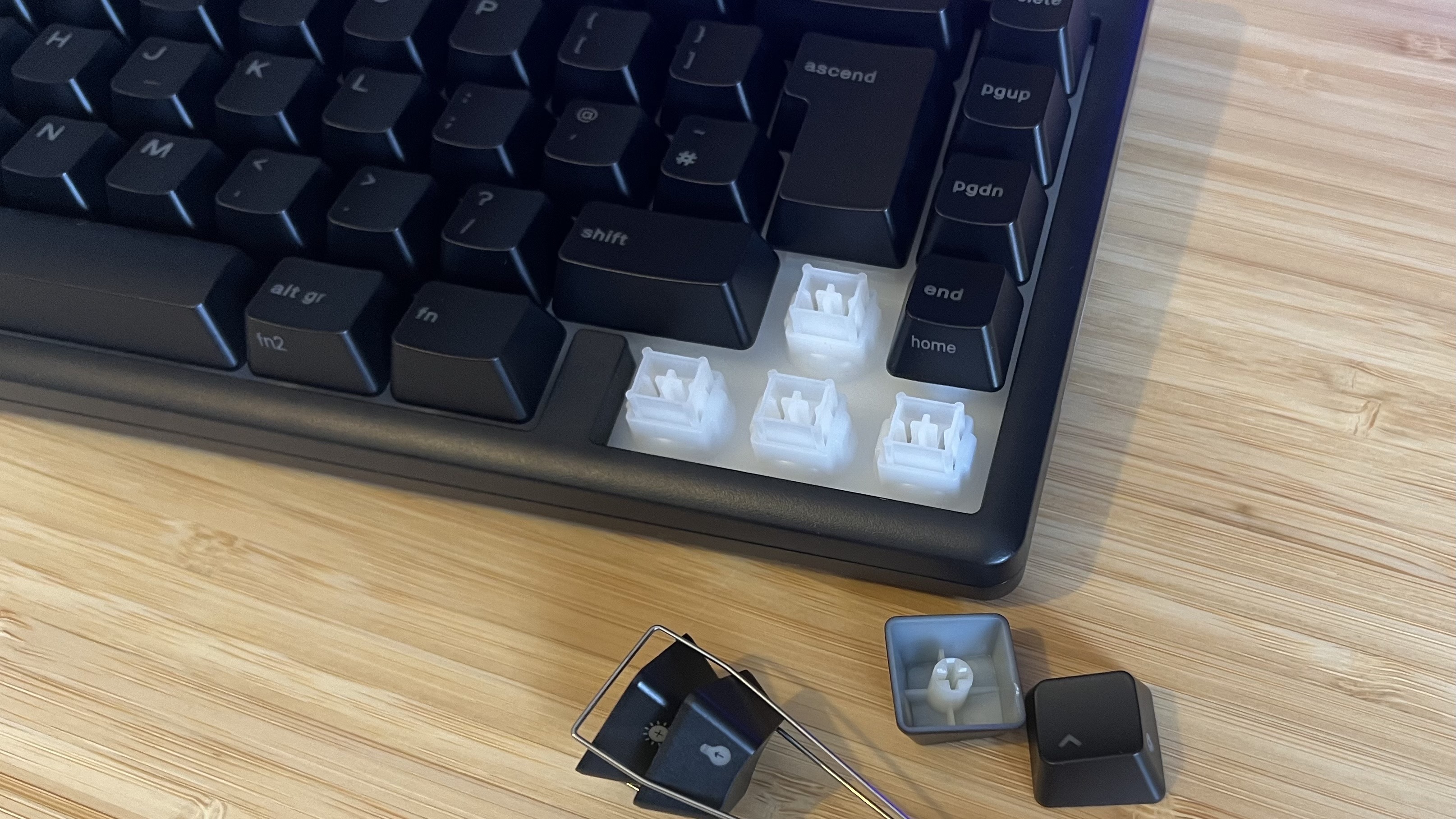 Glorious GMBK 75% gaming keyboard with arrow key caps removed showing switches