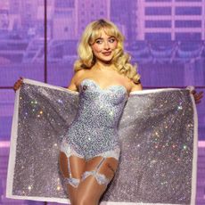 Sabrina Carpenter on the short n sweet tour wearing a diamond bustier with tights and a matching babydoll