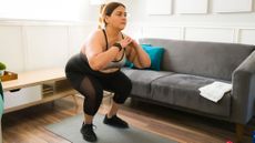 Do 30-day fitness challenges work: Image shows woman doing squats