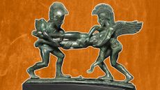 two helmeted bronze figures hold a horizontal corpse between them