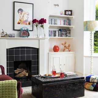 living room with fireplace and white wall with cabinet