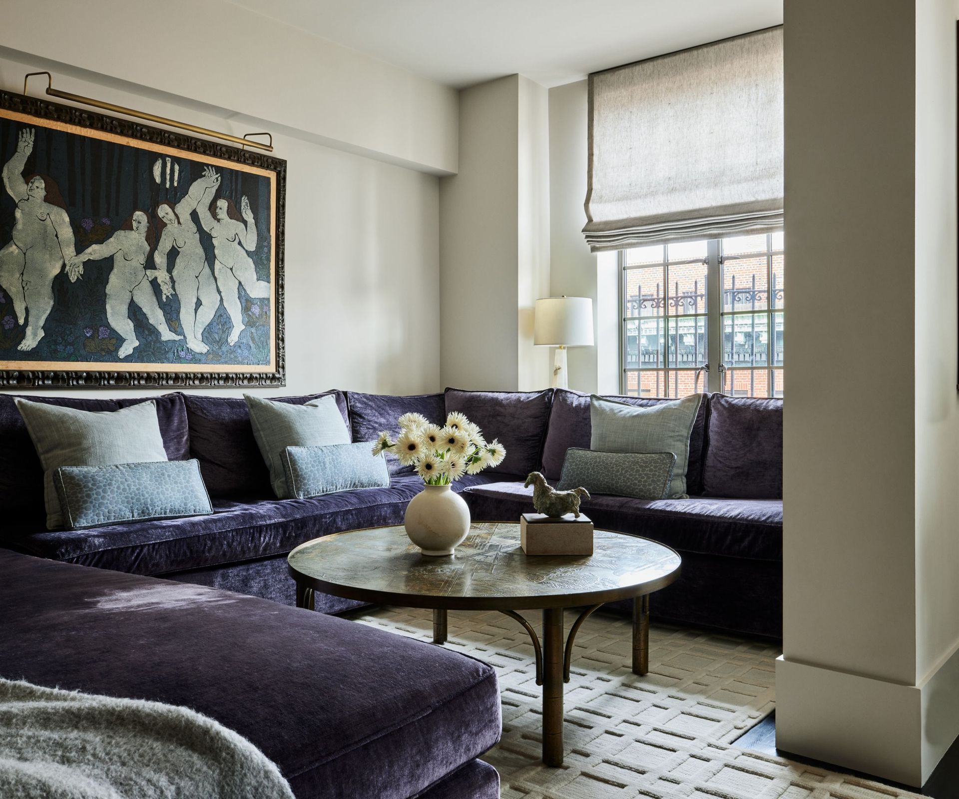 snug with dark furniture and large artwork on wall
