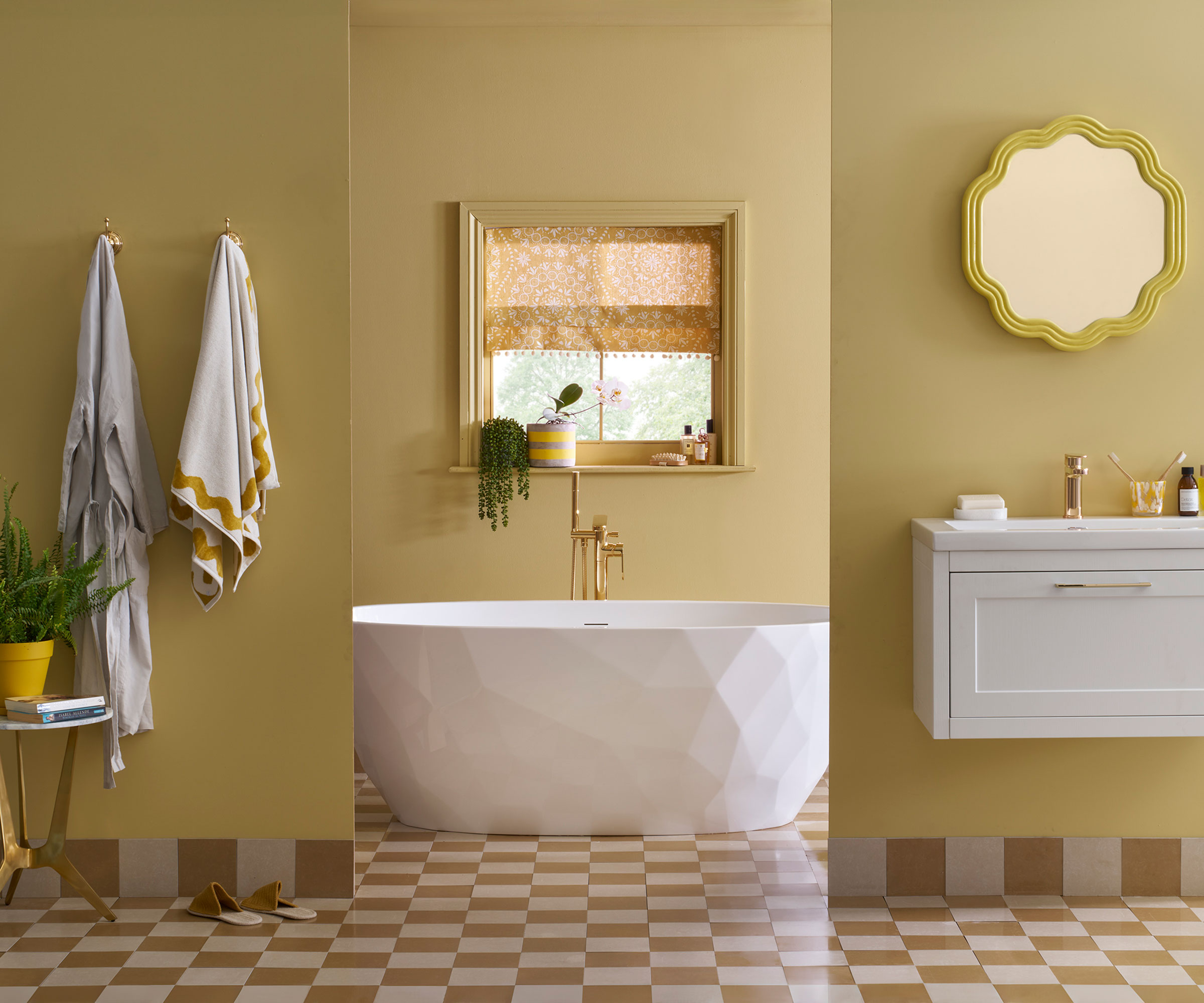 yellow bathroom with yellow and white chequerboard flooring and white designer freestanding bath