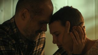 Jim Hopper (David Harbour) and Eleven (Millie Bobby Brown) embrace on Stranger Things.