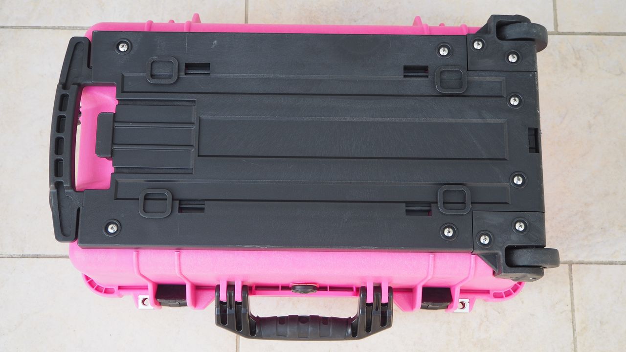 Peli / Pelican 1510 protector case in bright pink on a flagstone floor