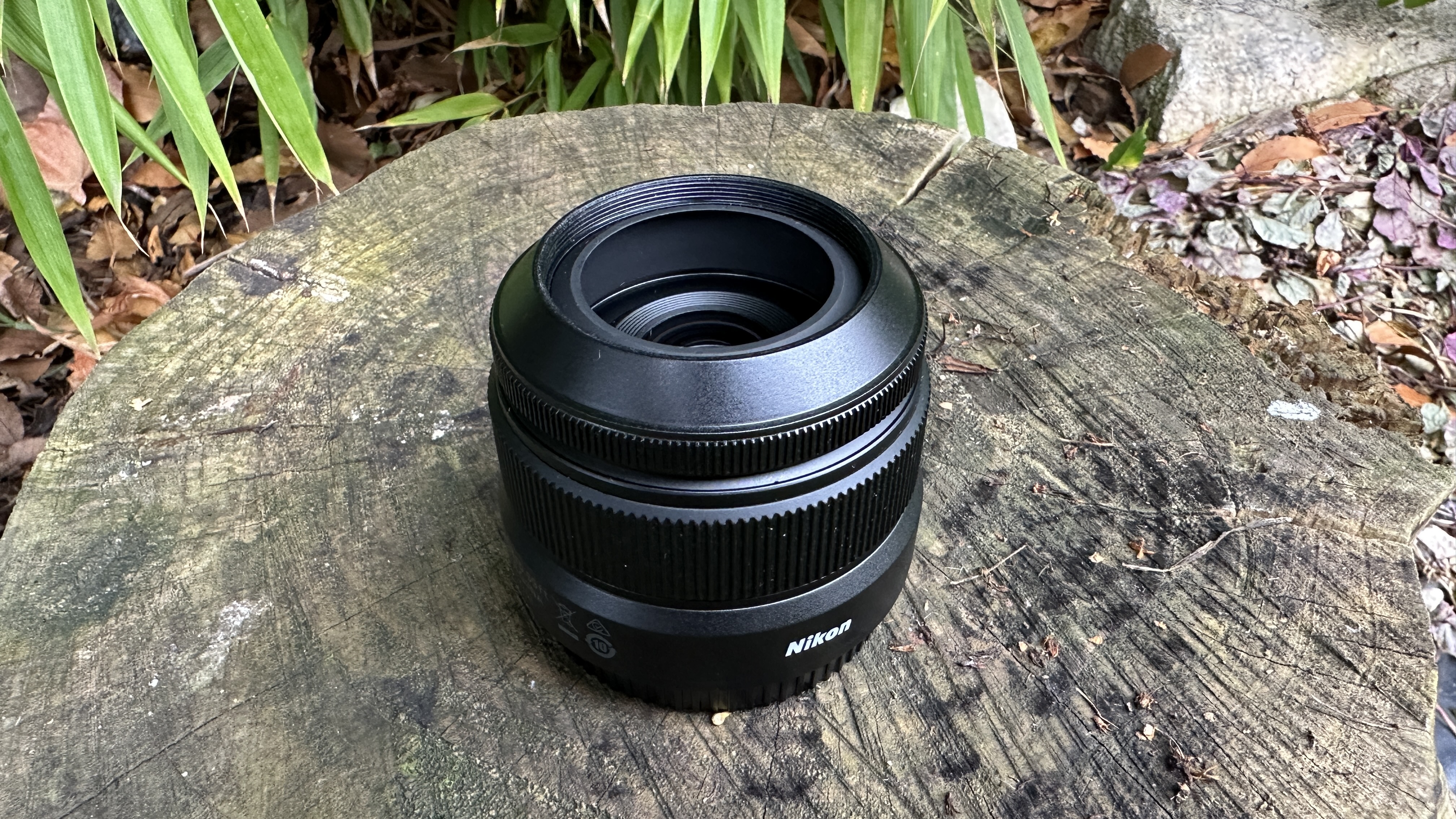 Nikkor Z DX 24mm f/1.7 lens with lens hood set to one side