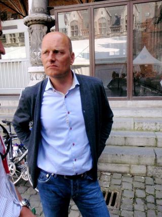 Bjarne Riis waited patiently outside as his riders were presented
