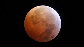 The moon looks red during a total lunar eclipse.