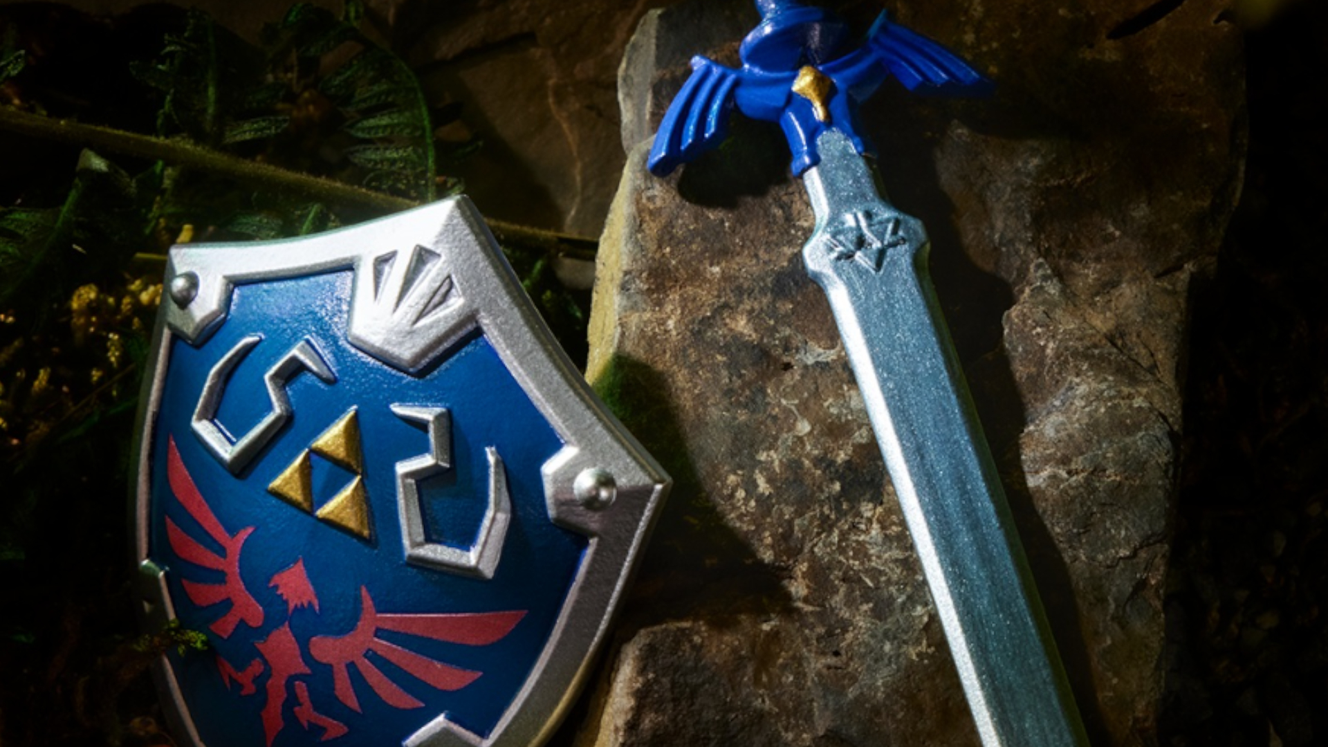 A Hylian Shield and the Master Sword leaning against a rock