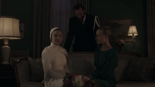 Eden talking with the Waterfords in The Handmaid's Tale after her marriage