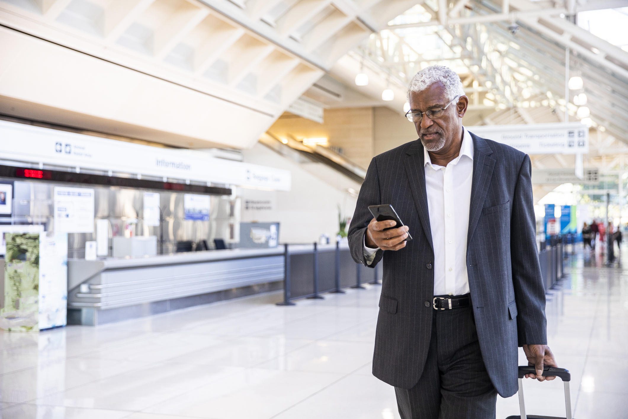 A man using his phone in the airport