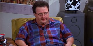 Newman sitting in his chair and looking angry on Seinfeld.