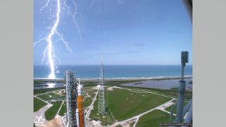 a lightning bolt stretching behind a rocket assembly