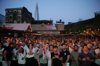 England supporters in Flat Iron Square in London react as they watch the 2018 World Cup semi-final between England and Croatia in Moscow on July 11, 2018