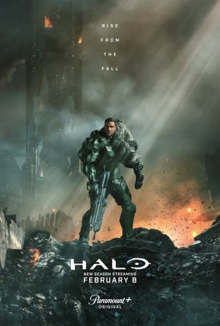 A poster for Halo season 2 showing Master Chief carrying a wounded soldier in a destroyed city