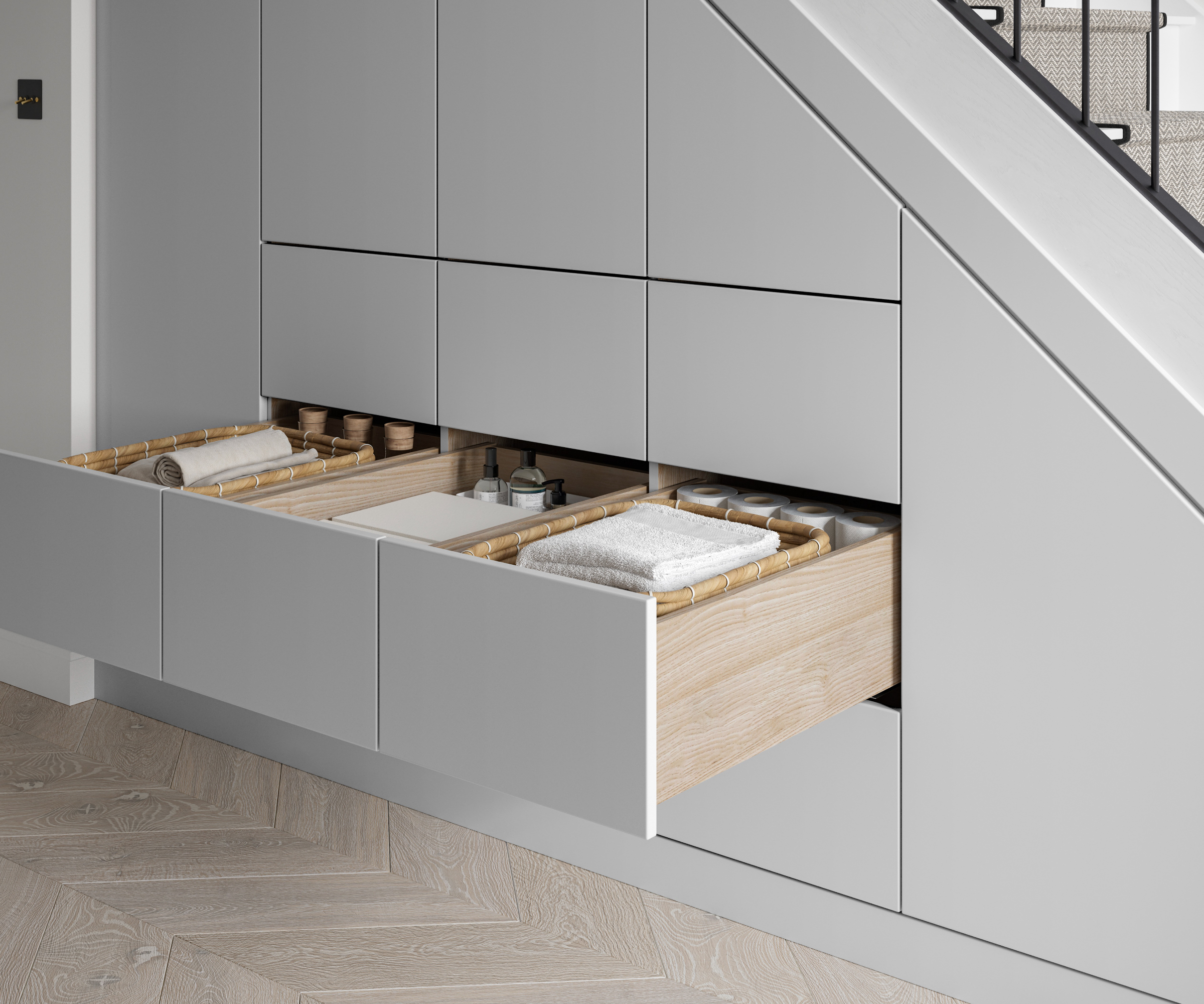 bespoke storage with cupboard doors and pull out drawer built into space below stairs
