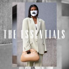 A woman wearing an oversized blazer. Text over image reads "The Essentials."