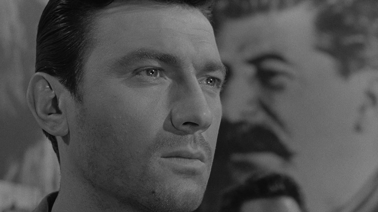 A close up of Laurence Harvey looking glassy-eyed in The Manchurian Candidate