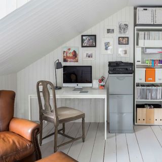 attic home office with white wall chair and white desk