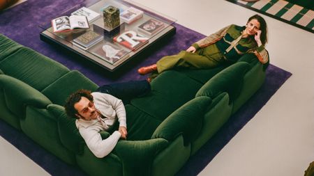 l'atelier ha designers on a green sofa and purple rug