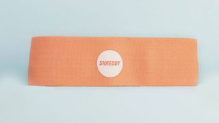 image of the orange SHREDDY Resistance Bands on a blue background