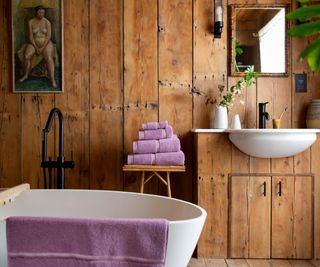 bathroom with rustic wooden panelling on walls and vanity unit