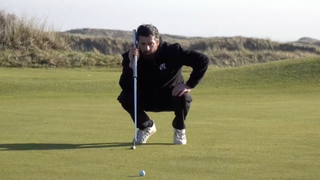 Photo of Joe Ferguson lining up a putt