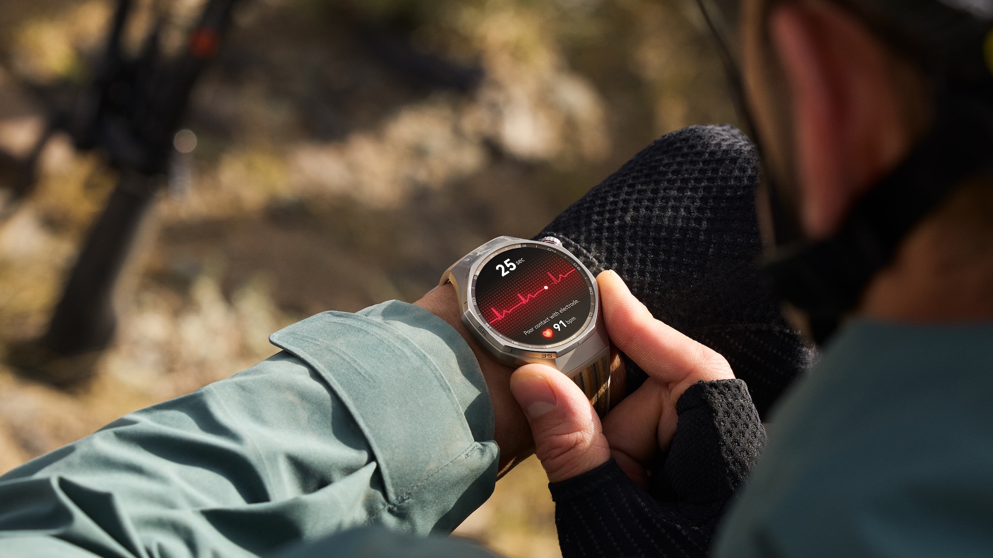 Promotional image of the HUAWEI WATCH GT6 PRO. A cyclist checks the heart rate monitor.