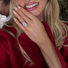 Elsa Hosk wears red dress for engagement photoshoot with engagement ring.