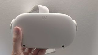 A picture of the Meta Quest 2 headset being held up