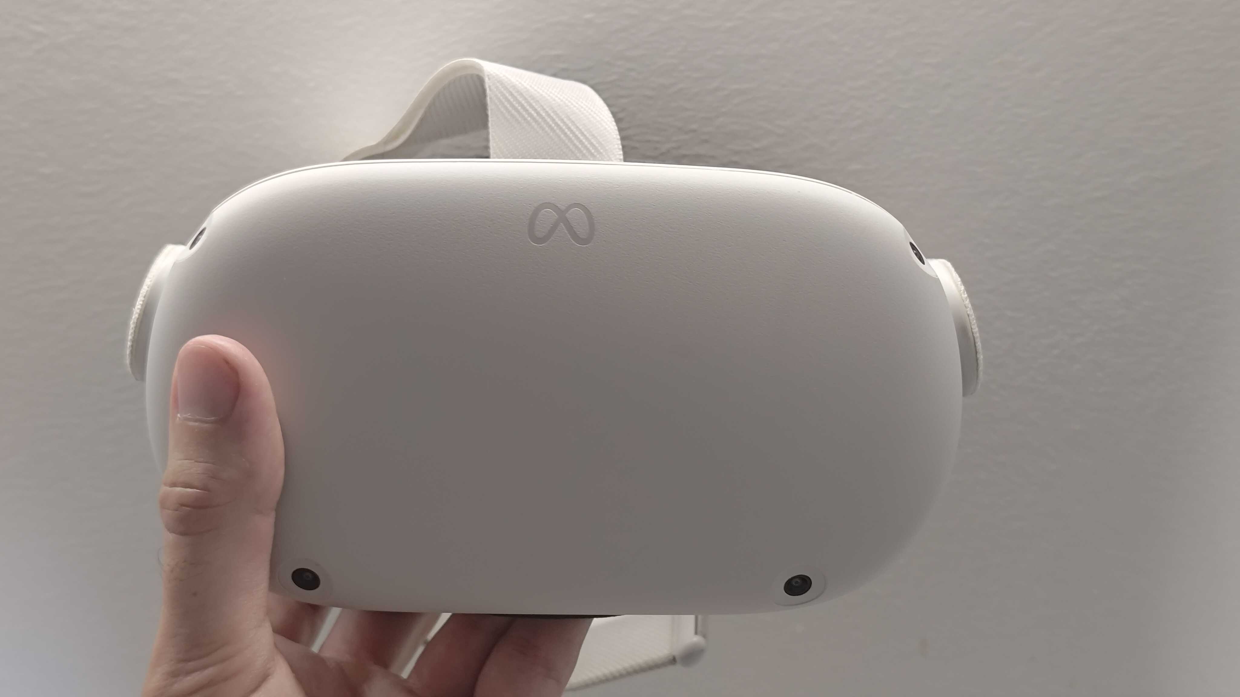 A picture of the Meta Quest 2 headset being held up