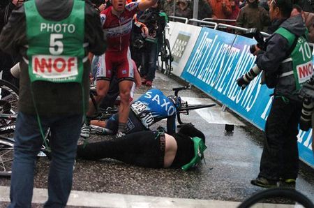 A photographer takes a tumble on a day of spills