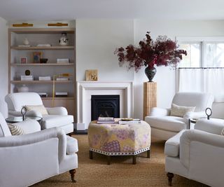 living room with white walls and white armchairs