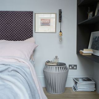 bedroom with hanging light and shelf