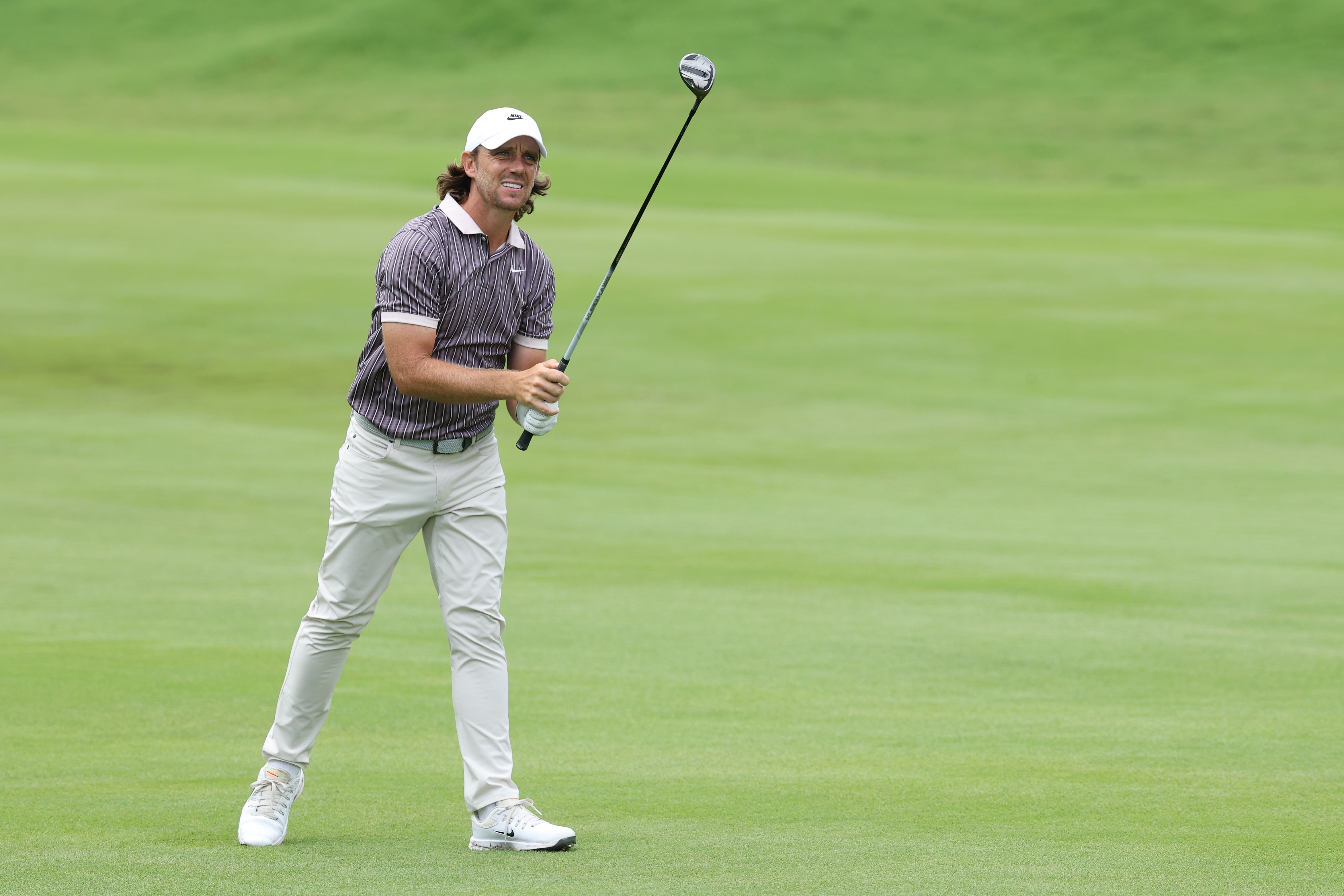 Tommy Fleetwood hits a fairway wood on the fairway