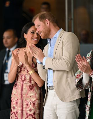 Meghan Markle wears a red and pink printed dress by Johanna Ortiz while in Bogota, Colombia.